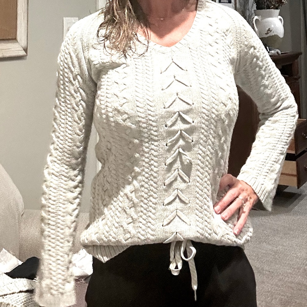 grey women’s sweater, v-neck. Fitted through shoulders and bust